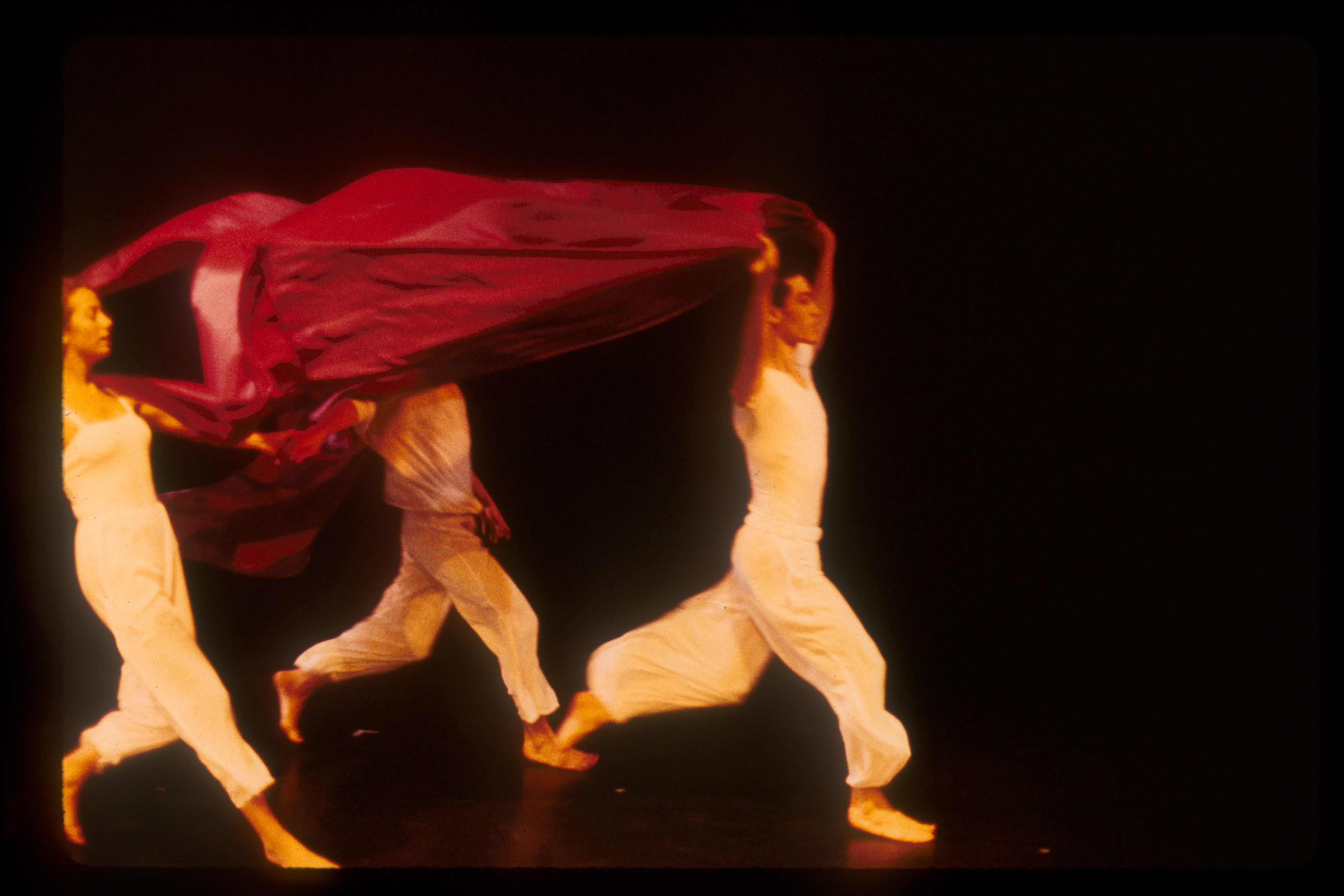 3 dancers running with red fabric - slide